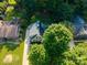 Aerial shot of a house with mature trees, landscaping, and a driveway leading to the property at 7521 Surreywood Pl, Charlotte, NC 28270