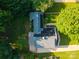 Aerial view of a home with a gray roof, lush greenery, and a well-maintained lawn at 7521 Surreywood Pl, Charlotte, NC 28270