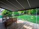 A covered back porch with wooden benches offers a serene outdoor living space overlooking a green backyard at 7521 Surreywood Pl, Charlotte, NC 28270