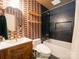 Modern bathroom with unique wallpaper, stylish vanity, and sleek, updated bathtub and fixtures at 7521 Surreywood Pl, Charlotte, NC 28270