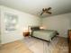 Bedroom features natural light, hardwood floors, and neutral decor at 7521 Surreywood Pl, Charlotte, NC 28270