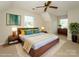 Bright bedroom with a ceiling fan, large bed, bedside tables, and lots of natural light at 7521 Surreywood Pl, Charlotte, NC 28270