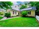 Inviting two-story home with solar panels, black shutters, mature landscaping, and a lush green lawn at 7521 Surreywood Pl, Charlotte, NC 28270