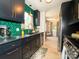 Modern kitchen features black cabinetry, granite countertops, and backsplash at 7521 Surreywood Pl, Charlotte, NC 28270