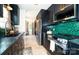Sleek kitchen with dark cabinets, stainless steel appliances, and stylish backsplash at 7521 Surreywood Pl, Charlotte, NC 28270