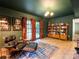 Living room with wood-paneled walls, and bookshelf at 7521 Surreywood Pl, Charlotte, NC 28270