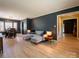 Open-concept living and dining area with hardwood floors, modern lighting, and neutral decor at 7521 Surreywood Pl, Charlotte, NC 28270
