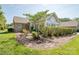 This property features a backyard with plush green grass and manicured landscaping at 8183 Sultana Cir, Charlotte, NC 28227