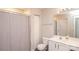Well-lit bathroom with a shower, toilet, white vanity, and updated fixtures providing a clean and modern feel at 8183 Sultana Cir, Charlotte, NC 28227