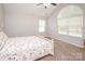 Spacious bedroom featuring a ceiling fan, plush carpet, and a large arched window for natural light at 8183 Sultana Cir, Charlotte, NC 28227