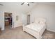 Comfortable bedroom boasts a ceiling fan, dresser, walk-in closet and plush carpet, creating a cozy retreat at 8183 Sultana Cir, Charlotte, NC 28227