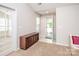 Welcoming entryway features tiled floors, storage cabinet, and an abundance of natural light at 8183 Sultana Cir, Charlotte, NC 28227