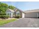 Charming single Gathering home featuring a one car garage and stone facade at 8183 Sultana Cir, Charlotte, NC 28227