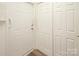 Hallway featuring modern wood floors, and multiple, bright white doors at 8183 Sultana Cir, Charlotte, NC 28227