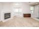 Bright living space with a cozy fireplace, French doors, and access to other rooms at 8183 Sultana Cir, Charlotte, NC 28227
