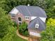 Beautiful brick home with mature trees, a two-car garage, and well-maintained roof at 8219 Beardsley Dr, Charlotte, NC 28269