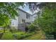 Beautifully landscaped backyard, deck, and partial view of home's exterior at 8219 Beardsley Dr, Charlotte, NC 28269