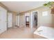 Open bathroom with soaking tub, glass shower, and walk-in closet access at 8219 Beardsley Dr, Charlotte, NC 28269