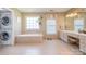 Bathroom with double vanity, soaking tub, and stacked washer/dryer unit at 8219 Beardsley Dr, Charlotte, NC 28269