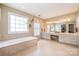 Large bathroom with double vanity, soaking tub, and abundant natural light at 8219 Beardsley Dr, Charlotte, NC 28269