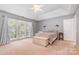 Spacious primary bedroom featuring tray ceiling and large windows at 8219 Beardsley Dr, Charlotte, NC 28269
