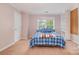 Bedroom featuring neutral walls, a double window, blue bedding, neutral carpet, and a closet at 8219 Beardsley Dr, Charlotte, NC 28269
