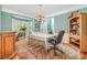 A dining room with a large bay window, a wood dresser, a persian rug, and wood flooring at 8219 Beardsley Dr, Charlotte, NC 28269