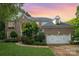 Charming brick home with a two-car garage, manicured lawn, and tasteful landscaping at 8219 Beardsley Dr, Charlotte, NC 28269