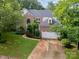 Well-maintained brick home with lush greenery, two-car garage, and a spacious driveway at 8219 Beardsley Dr, Charlotte, NC 28269