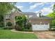 Charming brick home with a two-car garage, manicured lawn, and tasteful landscaping at 8219 Beardsley Dr, Charlotte, NC 28269