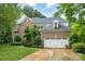 Well-maintained brick home with lush greenery, two-car garage, and a spacious driveway at 8219 Beardsley Dr, Charlotte, NC 28269