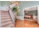 Inviting foyer with hardwood floors, a staircase, and views into the dining room at 8219 Beardsley Dr, Charlotte, NC 28269