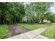 Well-manicured front yard with lush green grass, complemented by a paved driveway and sidewalk at 8219 Beardsley Dr, Charlotte, NC 28269