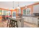 Open kitchen with stainless appliances, a center island, stone countertops, and an adjacent dining area at 8219 Beardsley Dr, Charlotte, NC 28269