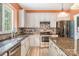 Well-lit kitchen featuring stainless steel appliances, stone countertops, tile backsplash, and ample counter space at 8219 Beardsley Dr, Charlotte, NC 28269