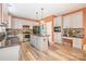 Well-appointed kitchen features stainless steel appliances, an island with granite countertops, and wood-style flooring at 8219 Beardsley Dr, Charlotte, NC 28269