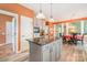 Beautiful kitchen featuring a center island, stainless steel appliances, stone counters, and seamless access to dining area at 8219 Beardsley Dr, Charlotte, NC 28269