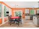 Eat-in kitchen with stone countertops, wood floors, dining table and chairs adjacent to the living room at 8219 Beardsley Dr, Charlotte, NC 28269