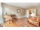 Cozy living room with hardwood floors, a piano, and a comfortable seating area at 8219 Beardsley Dr, Charlotte, NC 28269