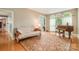 Comfortable living room with hardwood floors, a futon, and large windows at 8219 Beardsley Dr, Charlotte, NC 28269