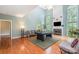 Open-concept living room featuring a pool table, fireplace, and large windows offering ample natural light at 8219 Beardsley Dr, Charlotte, NC 28269