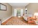 Neutral living room with a futon, hardwood floors, and access to another room at 8219 Beardsley Dr, Charlotte, NC 28269