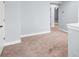Well-lit bedroom with neutral walls and carpeted floors adjacent to other rooms at 867 Pecan Tree Ln, Fort Mill, SC 29715