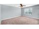 An inviting bedroom with neutral walls, plush carpeting, and a bright window at 867 Pecan Tree Ln, Fort Mill, SC 29715