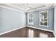 Serene bedroom with hardwood floors, crown molding, a tray ceiling, and two windows for natural light at 867 Pecan Tree Ln, Fort Mill, SC 29715