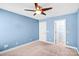 A bright bedroom with blue walls, neutral carpeting, and a closet at 867 Pecan Tree Ln, Fort Mill, SC 29715