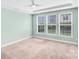 A light filled bedroom featuring a large window with blinds and neutral carpeting at 867 Pecan Tree Ln, Fort Mill, SC 29715