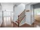 Beautiful staircase in the front hallway with hardwood floors and decorative banister at 867 Pecan Tree Ln, Fort Mill, SC 29715