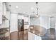 Open kitchen featuring a large island with granite countertops, stainless steel appliances, and hardwood floors at 867 Pecan Tree Ln, Fort Mill, SC 29715