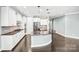 Modern kitchen with white cabinets, stainless steel appliances, and a curved granite-topped island at 867 Pecan Tree Ln, Fort Mill, SC 29715